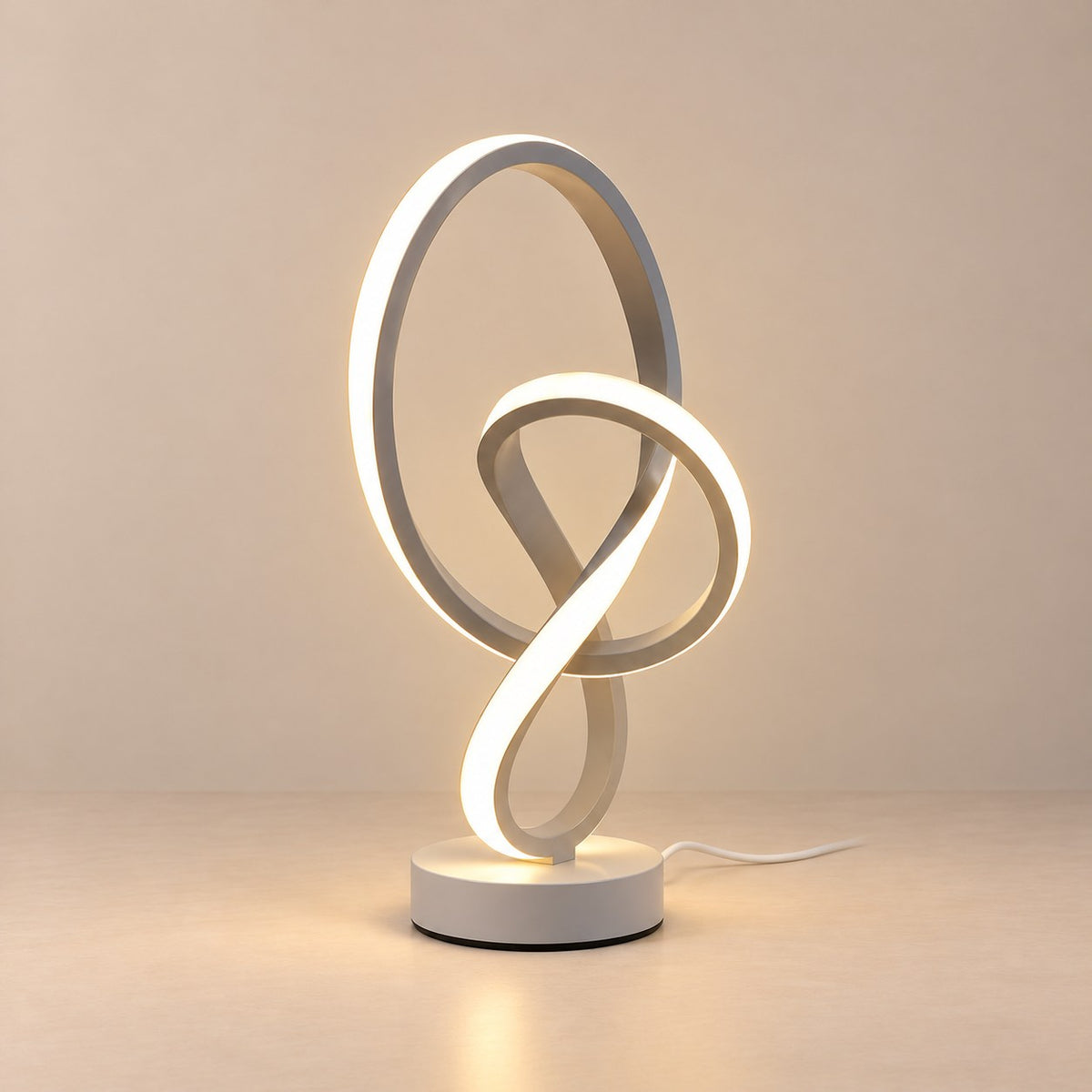 Lampe à poser LED design en forme de nœud, blanche, sur fond clair
